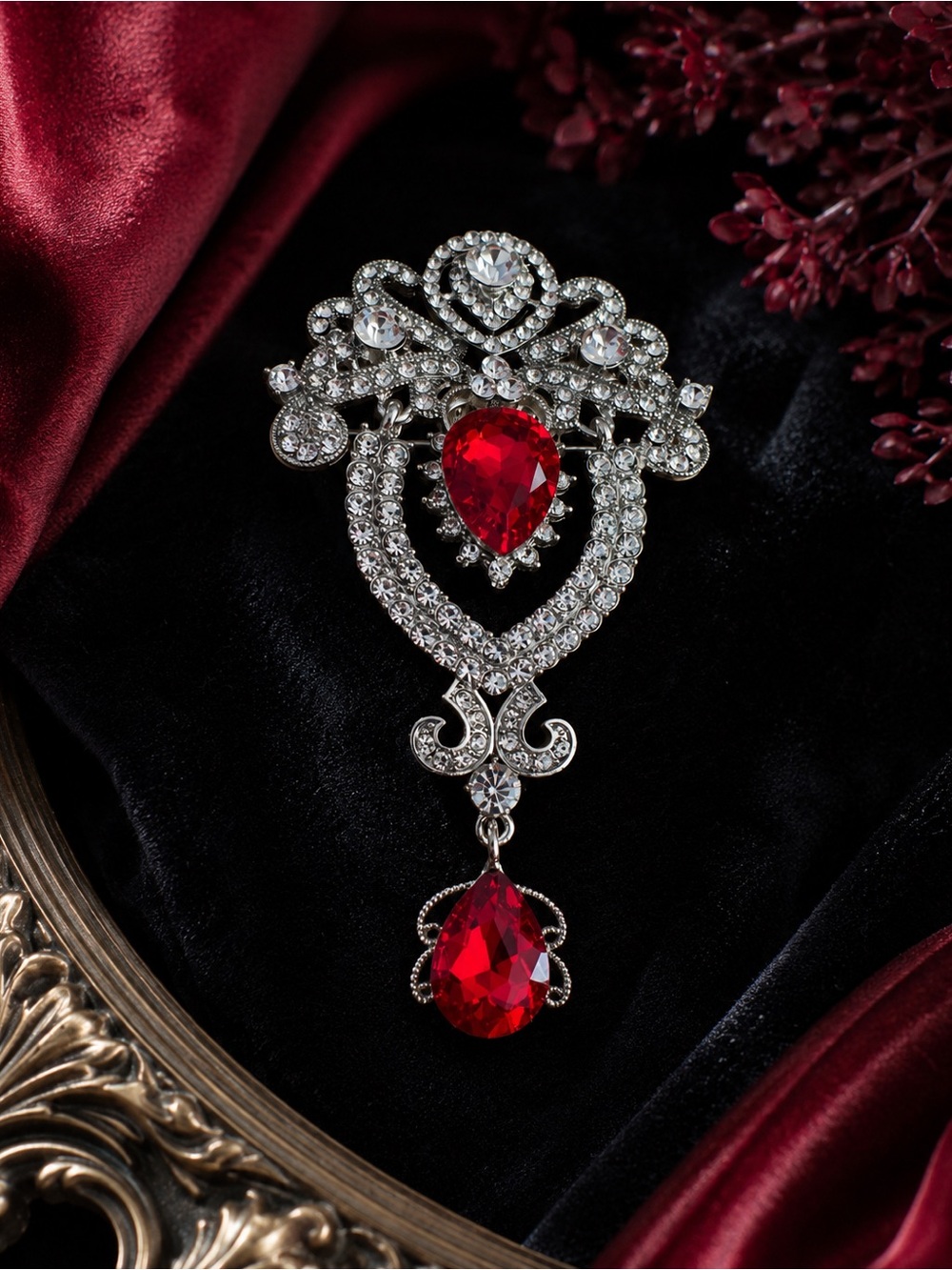 Vintage-Inspired Silver Brooch with Red Teardrop Crystals
